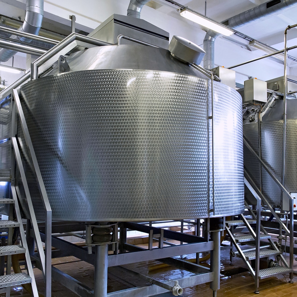 Stainless steel dairy storage tanks requiring temperature-controlled chiller cooling