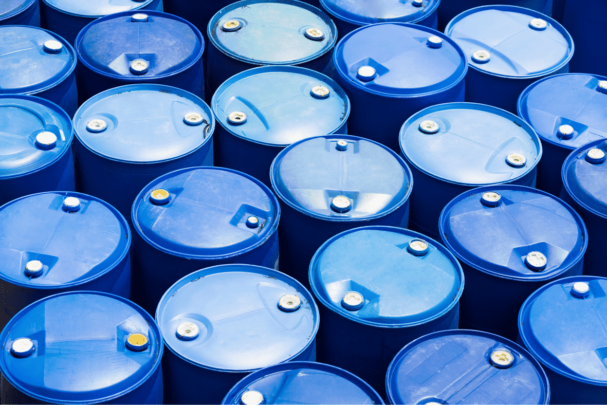 Blue plastic barrels and drums used for storing glycol coolant and chemicals in industrial cooling applications
