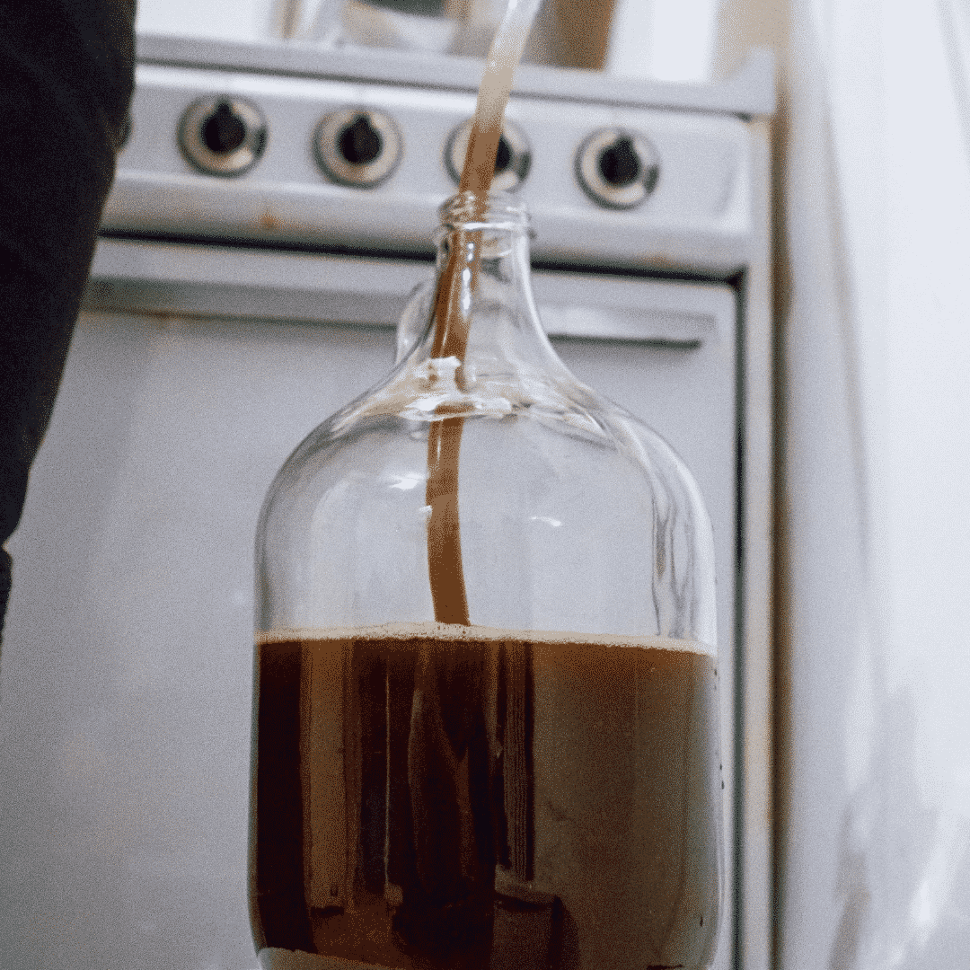 Glass carboy used for homebrewing and fermentation requiring temperature-controlled cooling during the process