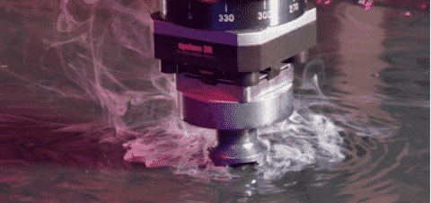 EDM wire cutting unit submerged in dielectric fluid