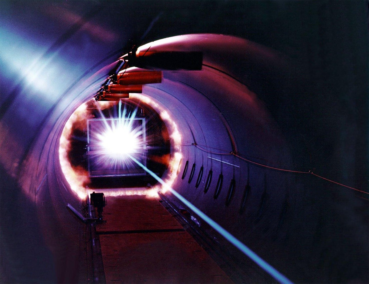 High-power laser beam test firing in a research facility demonstrating the extreme heat output that requires dedicated chiller cooling