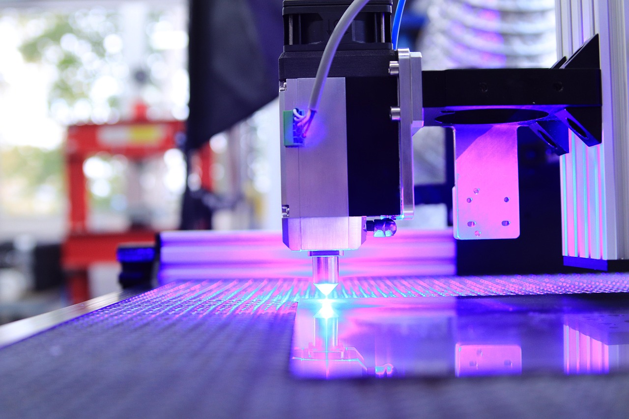 Industrial laser cutting machine with focused blue beam precisely cutting metal in a manufacturing facility
