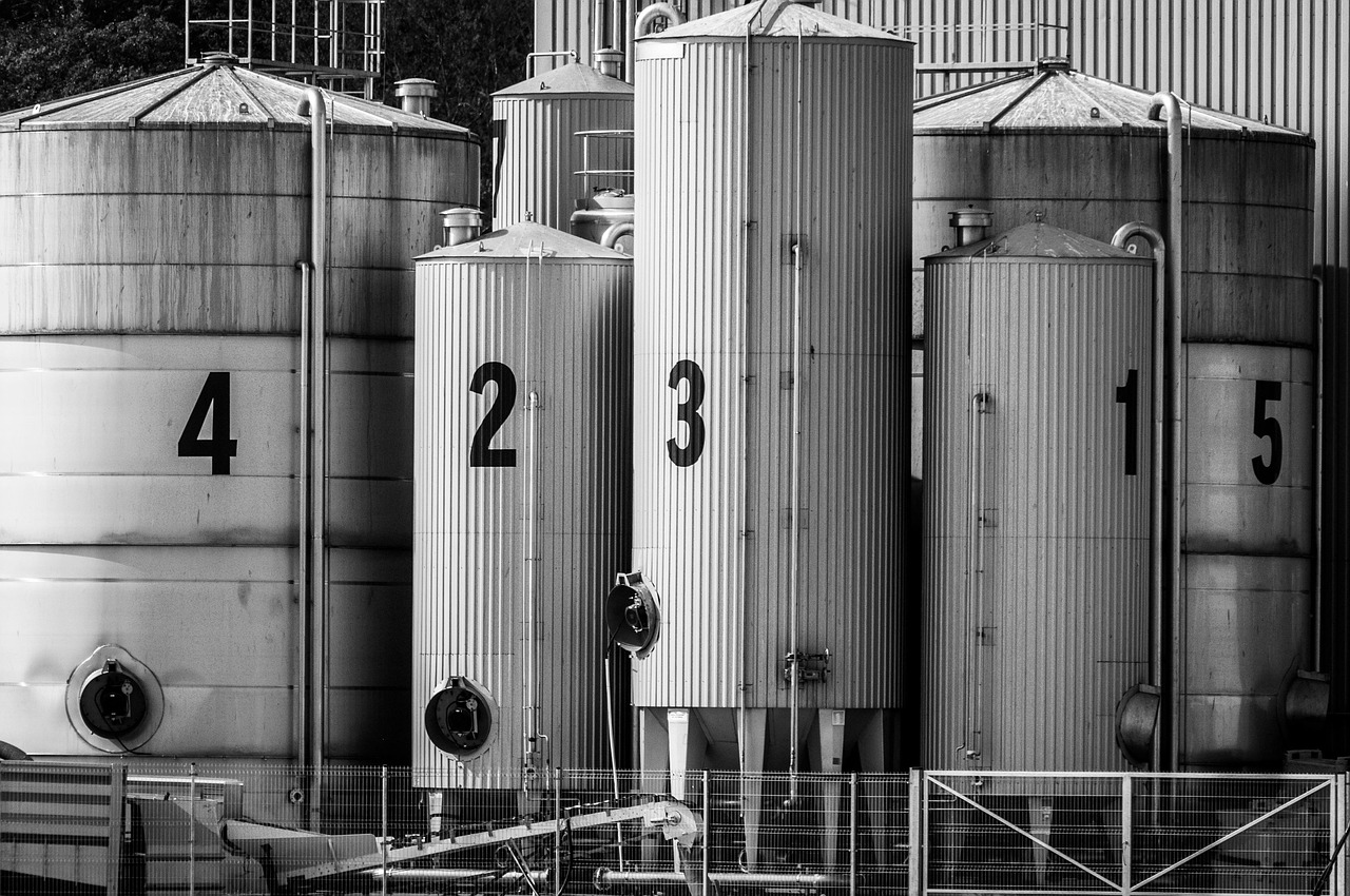 Row of large industrial stainless steel tanks at a manufacturing facility requiring process cooling and temperature control