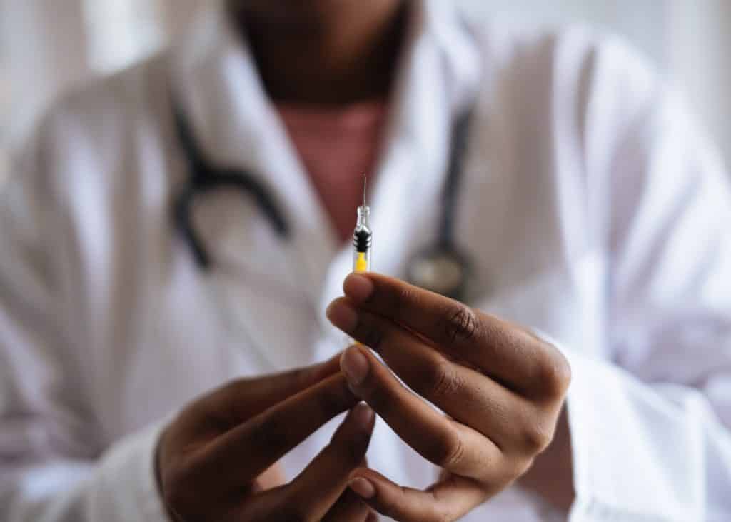 Person holding injection — how vaccines work and why temperature matters guide from North Slope Chillers