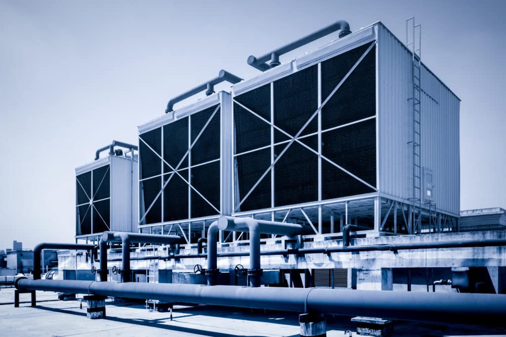 Rooftop cooling towers on a commercial building providing HVAC and industrial process temperature regulation