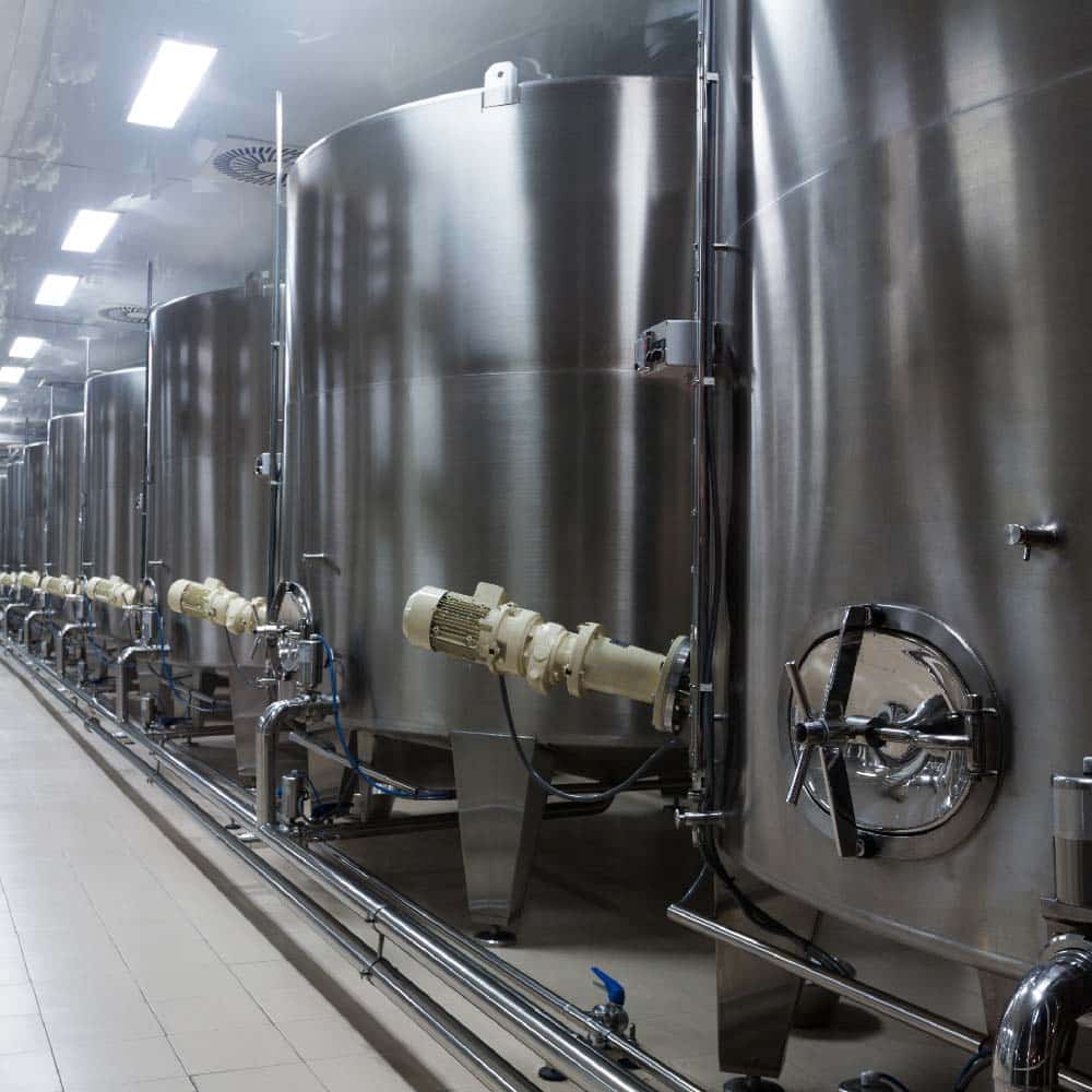 Stainless steel fermentation tanks with cooling jackets in a brewery