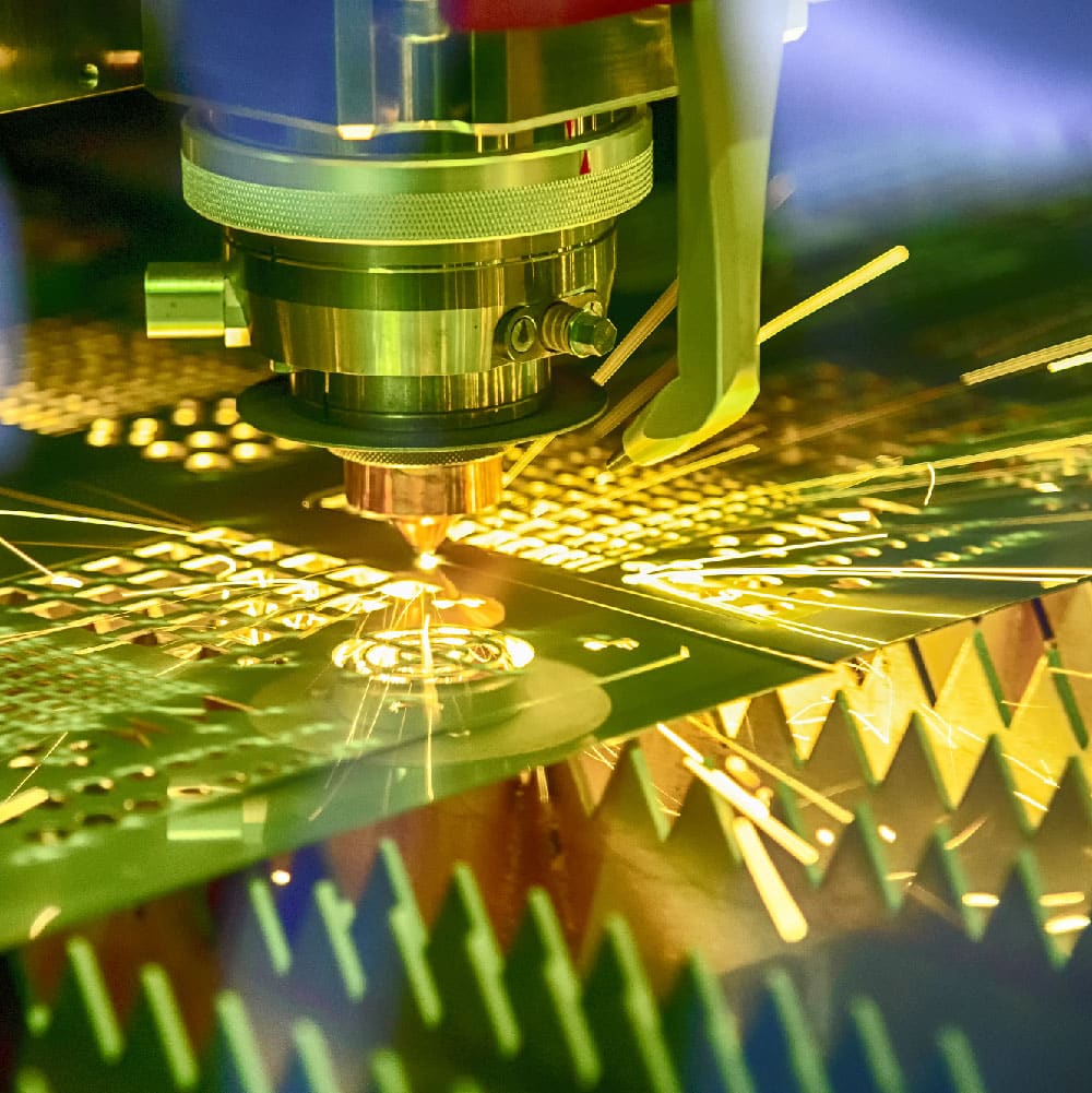 Precision laser cutting machine slicing through metal with a focused beam requiring water-cooled chiller systems