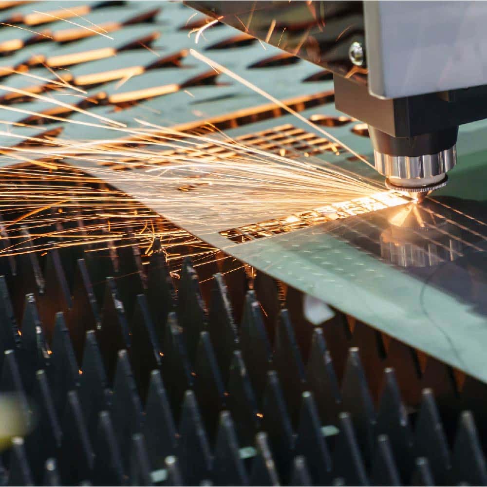 Industrial laser cutting operation requiring chiller cooling to maintain beam precision
