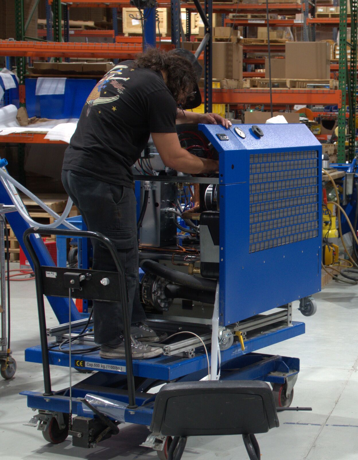 Technician assembling a North Slope Chillers unit on the production floor