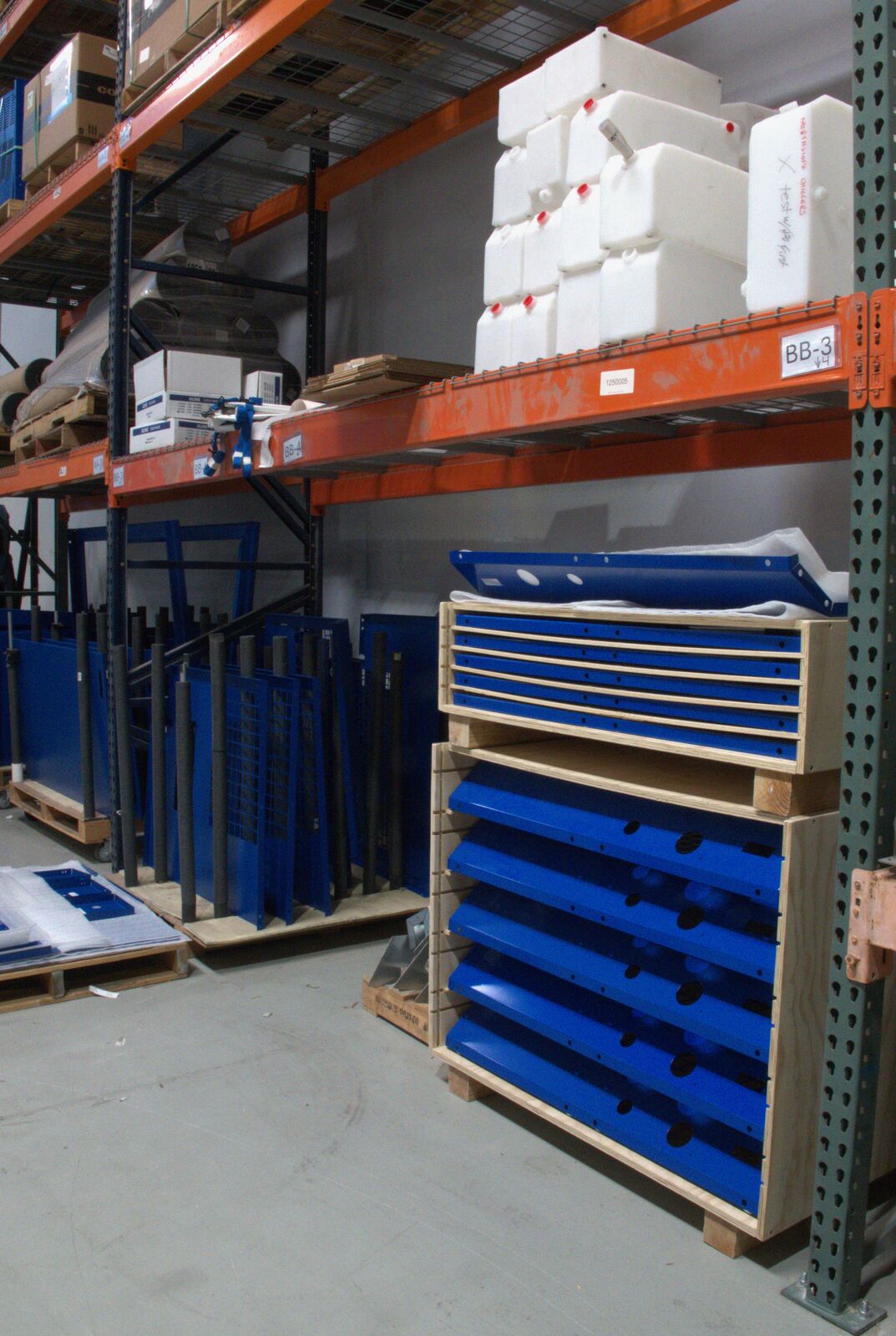 Blue chiller panels stacked on warehouse racks