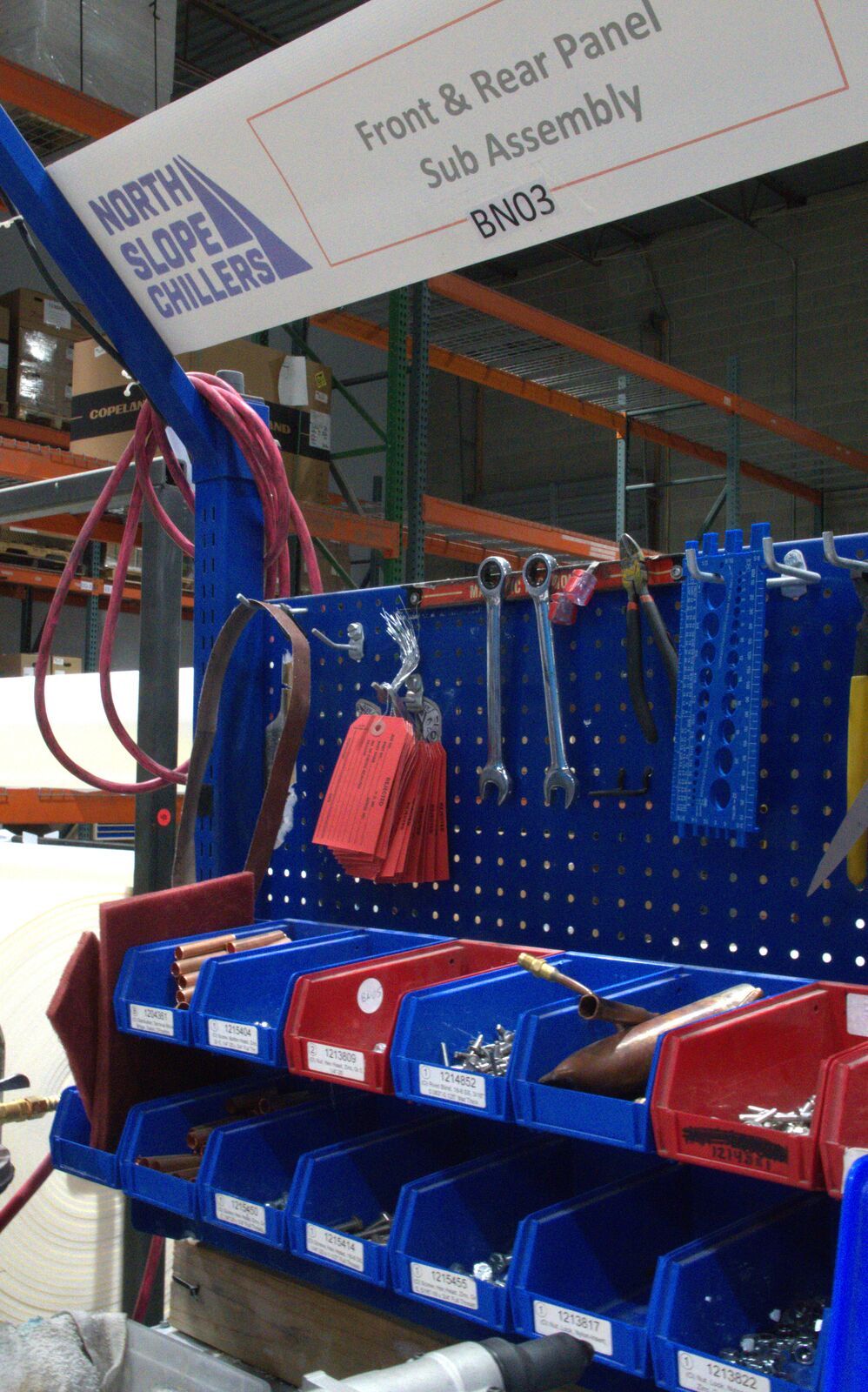 Front and rear panel sub-assembly station with North Slope Chillers branding